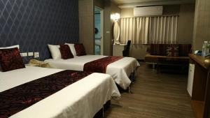 Postel nebo postele na pokoji v ubytování Guan Lun Hotel