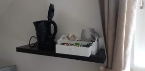 a shelf with a hair dryer and other items on it at Hotel Elfenmühle in Bad Bertrich