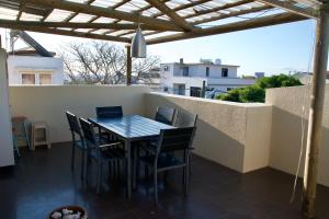 a table and chairs on the balcony of a house at Zanana Penthouse in Flic-en-Flac