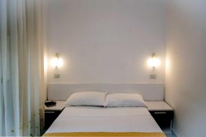 Postel nebo postele na pokoji v ubytování Hotel De Rosa