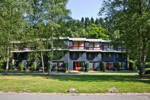 a large building with trees in front of it at Domaine Long Pre in Stavelot