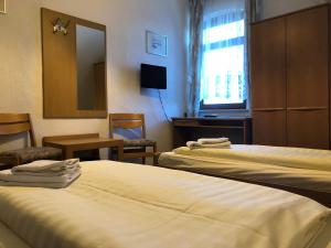 Postel nebo postele na pokoji v ubytování Krügers Hotel