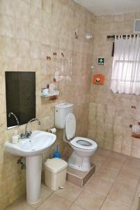 a bathroom with a toilet and a sink at Belamandil Garden ,family holidays ,caminho do torrejao olhao in Olhão