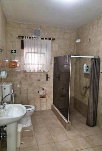 a bathroom with a shower and a toilet and a sink at Belamandil Garden ,family holidays ,caminho do torrejao olhao in Olhão