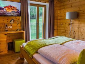 a bedroom with a bed and a large window at Sport Hotel in Livigno