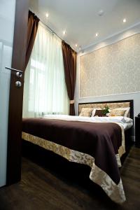 a bedroom with a large bed with a window at Boutique Hotel Leningrad in Saint Petersburg