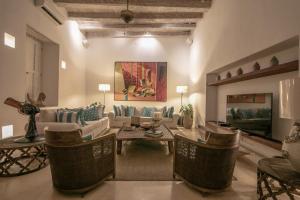 a living room with a couch and a table and chairs at Hotel Noi 1860 Cartagena in Cartagena de Indias +66 photos