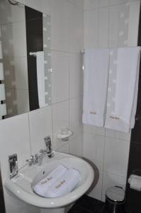 a bathroom with a sink and a mirror and towels at Casa Real Hoteles in Cusco