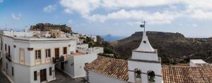 a church with a cross on top of a building at Nostos Guesthouse in Kythira