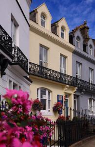 a white building with flowers in front of it at Number 7 Guest House in Whitby