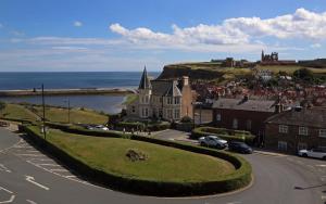 an aerial view of a town with a church and the ocean at Number 7 Guest House in Whitby