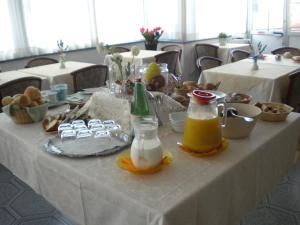 a white table with food and drinks on it at Hotel Villa Amelia in Alassio