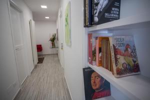a hallway with bookshelves filled with books at B&B al Centro in Messina