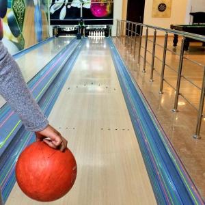 a person holding a ball at a bowling alley at Cennet Bagi Guba Hotel in Quba +116 photos