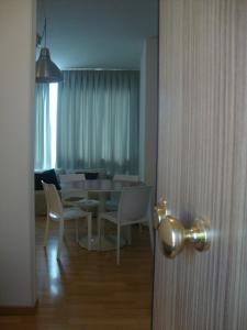 a room with a table and chairs and a dining room at Residenze Venezia Apartments in Mestre