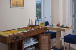 a table with plates of food on top of it at Chalet O Amorzinho Sintra Praia in Sintra