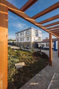 a large white building in front of a building at Chalet O Amorzinho Sintra Praia in Sintra