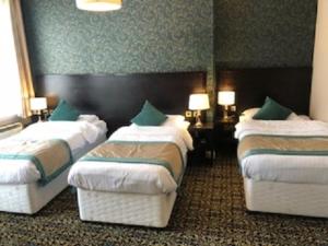 A bed or beds in a room at Globe Hotel Wetherspoon 