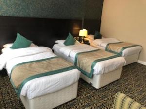 A bed or beds in a room at Globe Hotel Wetherspoon 