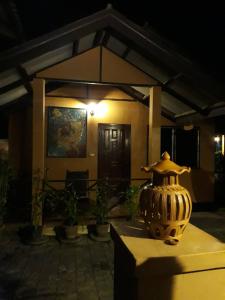 a vase sitting on a table in front of a house at Charlie's House in Pai