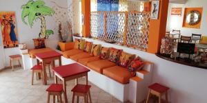 a store with orange seats and stools in a room at B&B Salinas Boa Vista WiFi FREE in Sal Rei