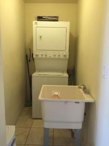 a small bathroom with a sink and an oven at Apartment Downtown Cananea in Cananea