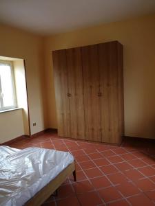 a bedroom with a bed and wooden cabinets at Il vigneto in Sessa Aurunca