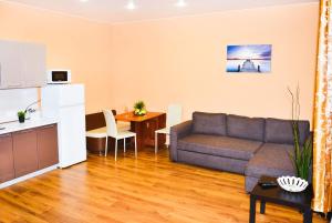 a living room with a couch and a table at W Apartaments Krepostnaya 12/2 in Vyborg