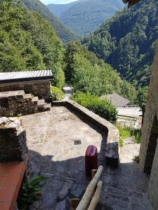 a stone patio with a view of a mountain at Casa Accogliente Valle Cannobina in Le Biuse