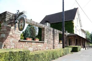 a brick building with a clock on the side of it at Le Robinson in Mézières-sur-Oise