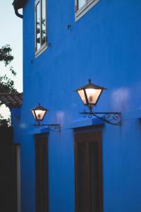 a blue building with two lights on the side of it at La Curia in Pontevedra