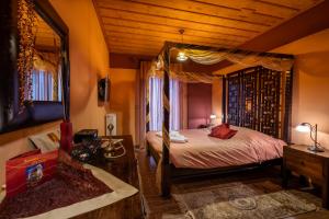 a bedroom with a canopy bed in a room at Ontas Guesthouse & Spa in Arachova