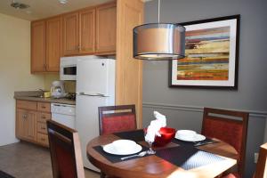 
a kitchen with a table and chairs and a refrigerator at Lodge at Kingsbury Crossing in Stateline
