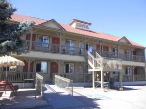 a hotel building with a table and an umbrella at Ute Motel in Fountain