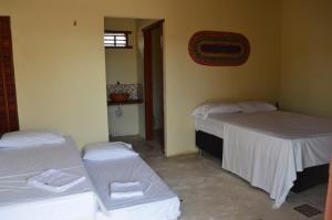 מיטה או מיטות בחדר ב-Pousada Lagunas