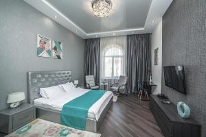 a hotel room with a bed and a television at MinskLux Apartments in Minsk