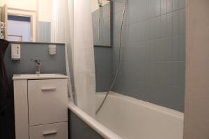 a bathroom with a tub and a sink and a shower at Studio 237 Port Camargue, Piscine, Climatisation, 2 personnes in Le Grau-du-Roi