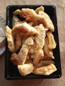 a black container filled with fried food on a table at Holiday Home Vila Milka in Kremna