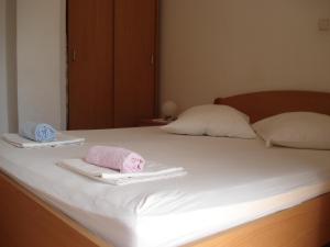 a bed with two towels on top of it at Guest House Karević in Hvar