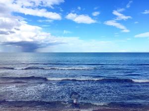 a view of the ocean on a cloudy day at Dar Corniche La Marsa (Adults Only) in La Marsa