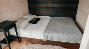 a small bed in a wooden cabin with a pillow on it at Scandidim Lutsk in Lutsk