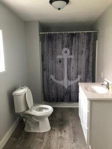 a bathroom with a toilet and a shower curtain at Niagara Falls (USA) Minutes to EVERYTHING in Niagara Falls +14 photos