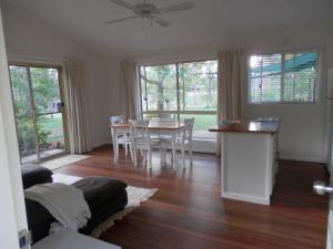 a living room with a couch and a table and chairs at Wondai Hideaway Apartment in Wondai