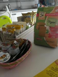 a counter with a basket of food and a bag of food at B&B Il Corallo in Bosa