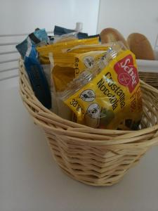 a basket with chips and other snacks in it at B&B Il Corallo in Bosa