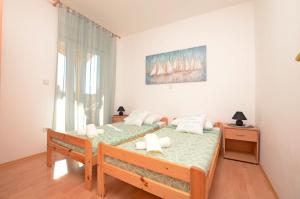 a bedroom with two beds and a window at Apartment Marija in Medulin