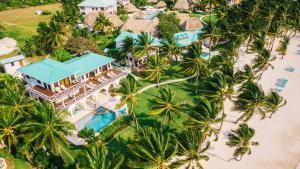 an aerial view of a resort with a pool and palm trees at Victoria House Resort & Spa in San Pedro