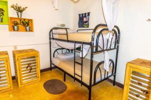 a room with two bunk beds in a room at The Purpose Hostel in Antigua Guatemala