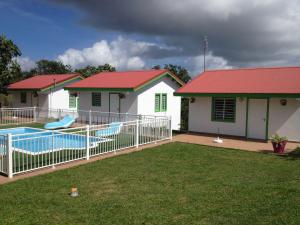 a house with a swimming pool in a yard at Gites Man-non in Sainte-Anne