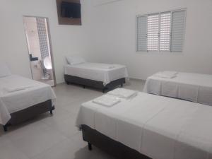 Ένα ή περισσότερα κρεβάτια σε δωμάτιο στο Hotel farol de Minas